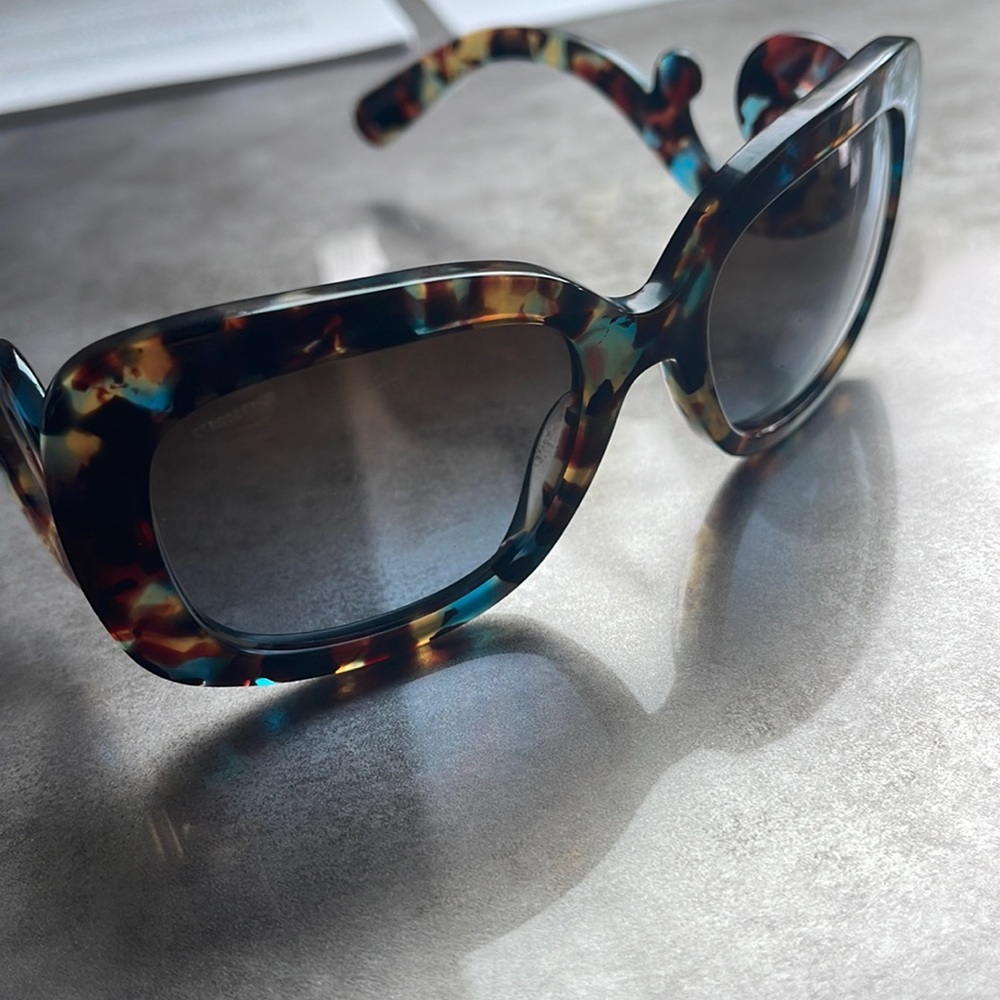 Woman’s gently used Prada sunglasses w Prada case.